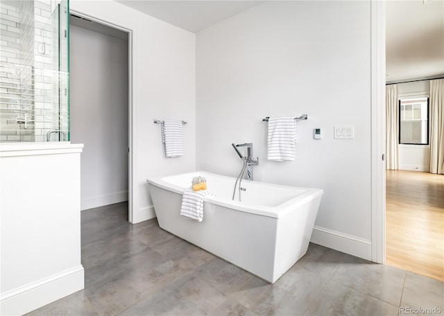 bathroom featuring shower with separate bathtub