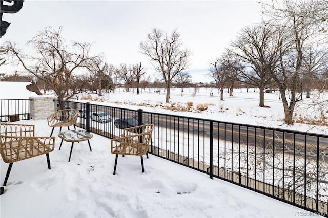 view of snow covered back of property