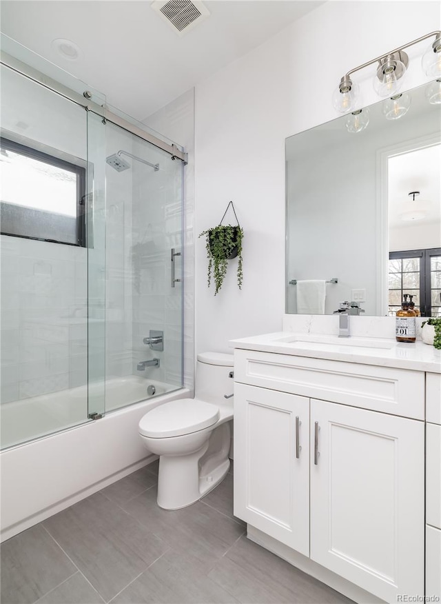 full bathroom featuring vanity, toilet, enclosed tub / shower combo, and tile patterned floors