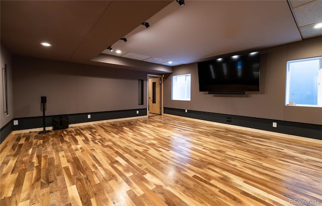 cinema with light wood-type flooring