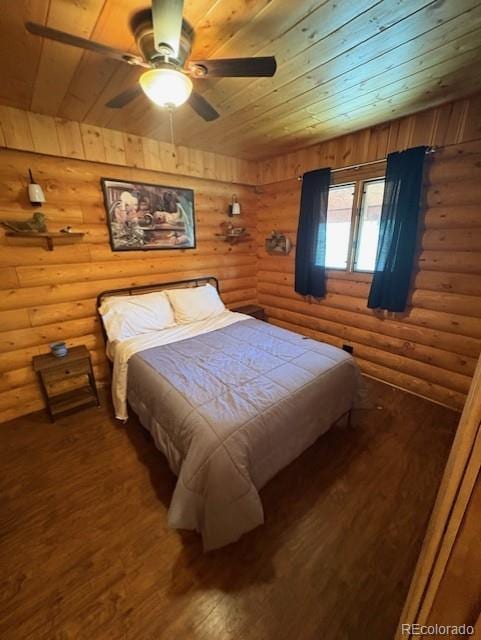 36 Hilltop Dr, Walden, CO 80480 - bedroom featuring rustic walls, wood-type flooring, wood ceiling, and a ceiling fan