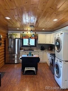 36 Hilltop Dr, Walden, CO 80480 - kitchen with appliances with stainless steel finishes, wooden ceiling, stacked washer / dryer, white cabinets, and dark wood-style floors