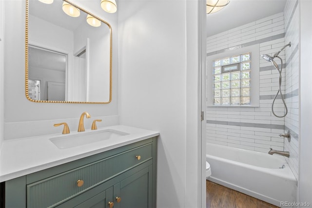 2140 S Washington St, Denver, CO 80210 - bathroom with vanity, toilet, washtub / shower combination, and wood finished floors