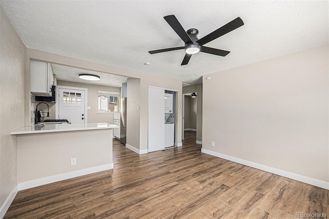 1148 Rosemary St, Denver, CO 80220 - unfurnished living room with wood finished floors, ceiling fan, and a textured ceiling