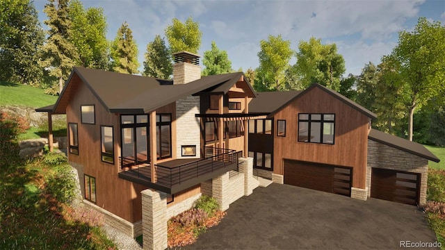 2035 Highlands Dr, Breckenridge, CO 80424 - view of front of house with driveway, stone siding, a garage, and a chimney