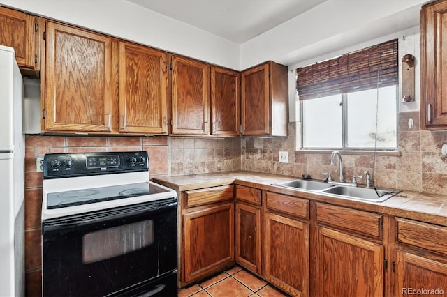 4940-42 W 9th Ave W, Denver, CO 80204 - kitchen with electric stove, decorative backsplash, brown cabinetry, and freestanding refrigerator
