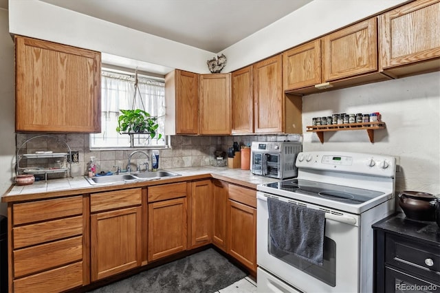 4940-42 W 9th Ave W, Denver, CO 80204 - kitchen featuring white electric stove, tile countertops, backsplash, and brown cabinetry