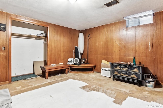 4940-42 W 9th Ave W, Denver, CO 80204 - bedroom with wood walls, a textured ceiling, and a closet
