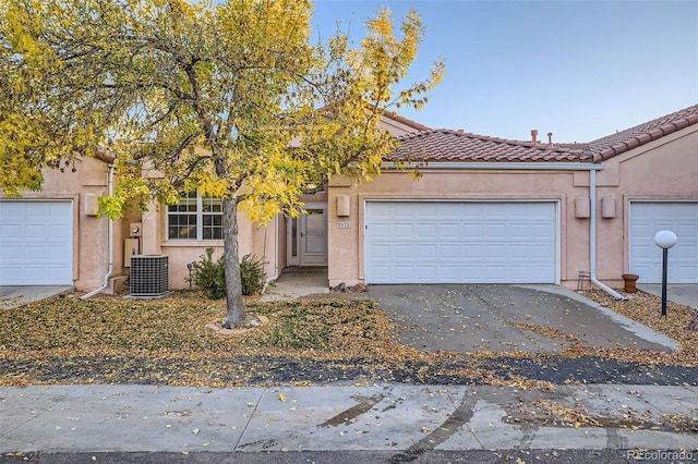 view of front of home featuring a garage and cooling unit