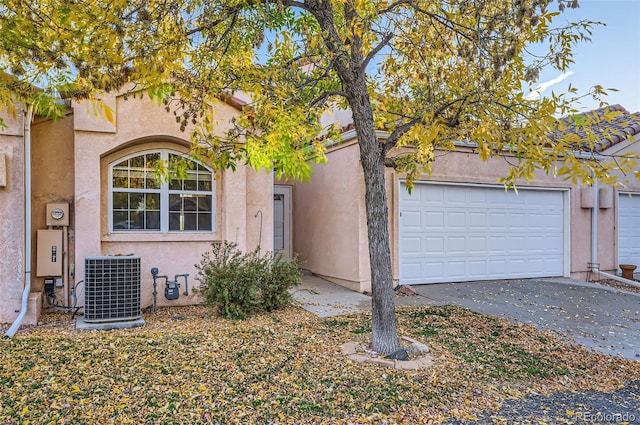 view of front of house featuring central AC and a garage