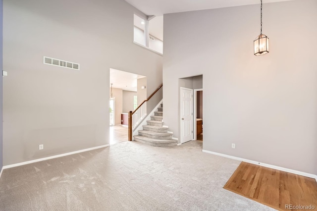 2856 Penstemon Way, Castle Rock, CO 80109 - carpeted spare room featuring baseboards, stairway, and a high ceiling