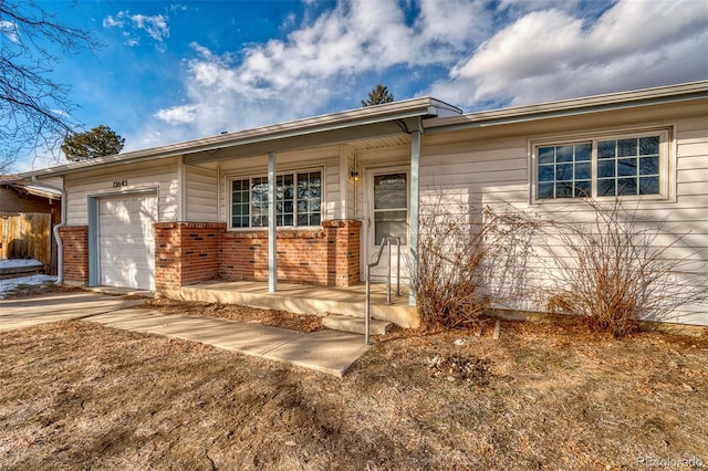 view of front of property with covered porch and a garage