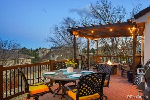 wooden deck featuring an outdoor fire pit and outdoor dining area