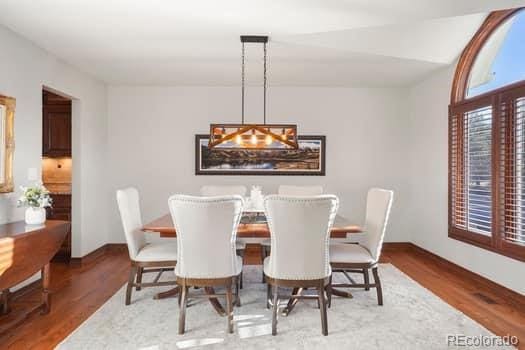 dining area featuring wood finished floors and baseboards