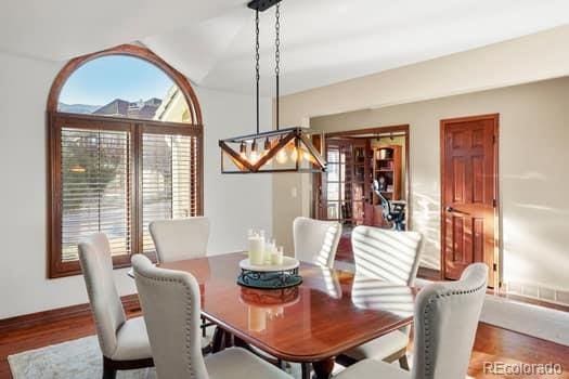 dining space with wood finished floors