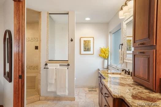 full bath with recessed lighting, vanity, and walk in shower