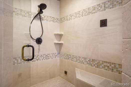 full bath featuring tiled shower