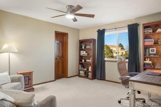 office with light colored carpet, ceiling fan, and baseboards