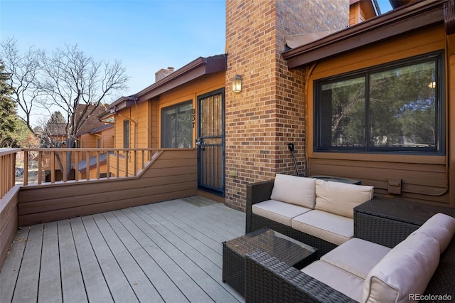 wooden terrace featuring outdoor lounge area