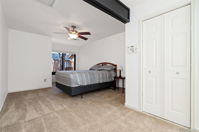 carpeted bedroom featuring a ceiling fan and baseboards