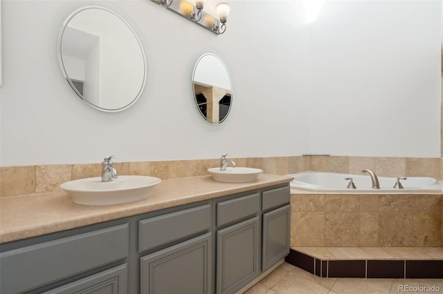 full bathroom featuring tile patterned floors, a bath, double vanity, and a sink