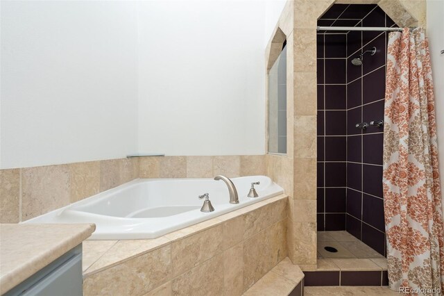 bathroom with a garden tub and a tile shower