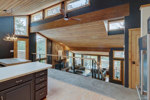 kitchen featuring wooden ceiling, light tile patterned floors, high end refrigerator, ceiling fan, and vaulted ceiling