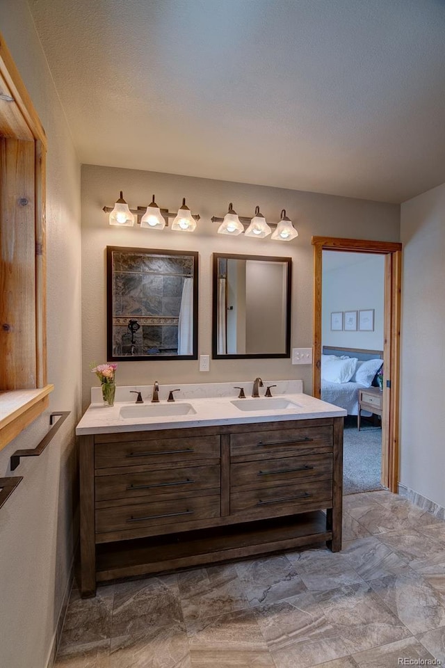 full bath with double vanity, ensuite bathroom, and a shower