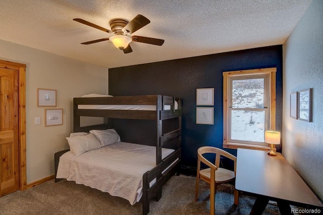 bedroom with carpet, a textured ceiling, ceiling fan, and a textured wall