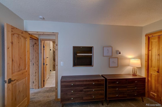 bedroom with carpet floors and a textured ceiling