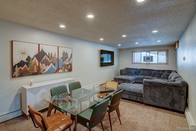 dining room with a baseboard heating unit, recessed lighting, a textured ceiling, and light carpet
