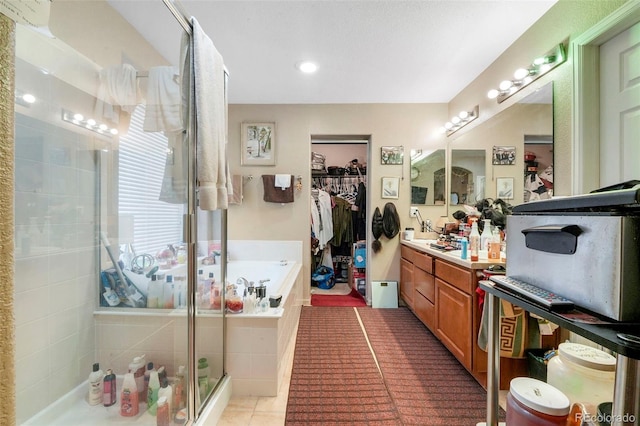 bathroom with plus walk in shower, vanity, and tile patterned floors