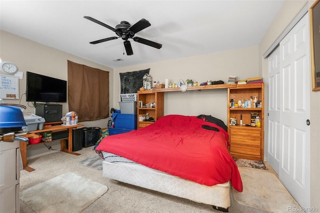 carpeted bedroom with ceiling fan and a closet