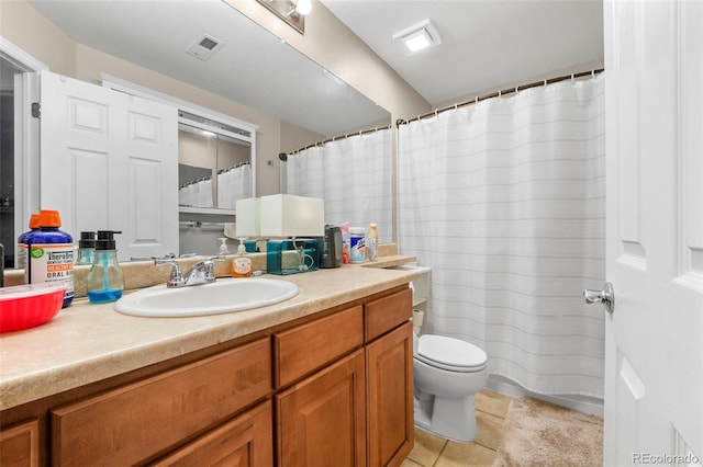 bathroom featuring toilet, vanity, and tile patterned floors