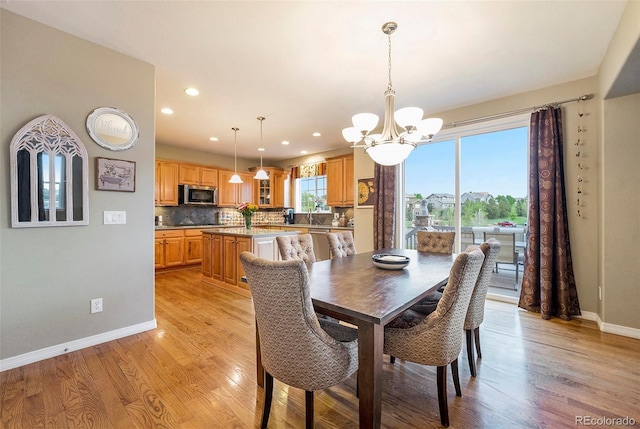 10705 Pinewalk Way, Highlands Ranch, CO 80130 - dining space with a chandelier, baseboards, light wood-style floors, and recessed lighting