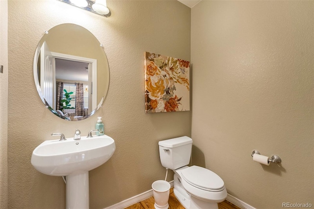 10705 Pinewalk Way, Highlands Ranch, CO 80130 - bathroom featuring toilet, wood finished floors, and baseboards