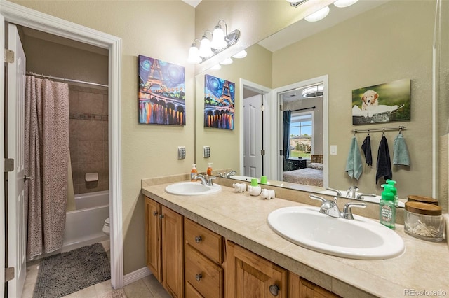 10705 Pinewalk Way, Highlands Ranch, CO 80130 - ensuite bathroom featuring double vanity, shower / bath combo with shower curtain, tile patterned flooring, and toilet