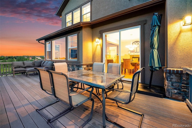 10705 Pinewalk Way, Highlands Ranch, CO 80130 - deck at dusk featuring outdoor dining space and an outdoor living space