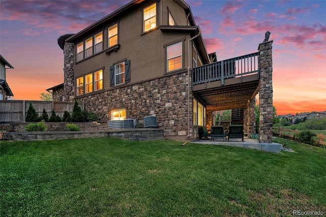 10705 Pinewalk Way, Highlands Ranch, CO 80130 - rear view of house with stone siding, a patio area, stucco siding, central AC, and a balcony
