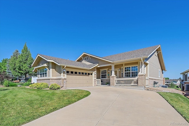 23425 E Otero Dr, Aurora, CO 80016 - view of front of house with a porch, a front yard, an attached garage, driveway, and brick siding