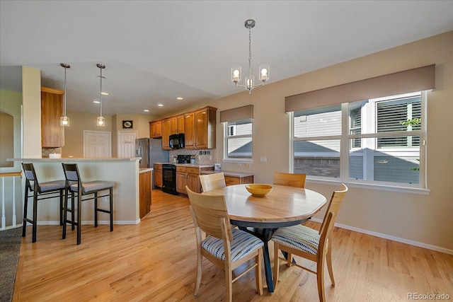 23425 E Otero Dr, Aurora, CO 80016 - dining area with plenty of natural light, light wood-style flooring, a chandelier, and recessed lighting
