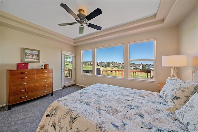 23425 E Otero Dr, Aurora, CO 80016 - bedroom featuring a raised ceiling, access to exterior, dark colored carpet, and a ceiling fan