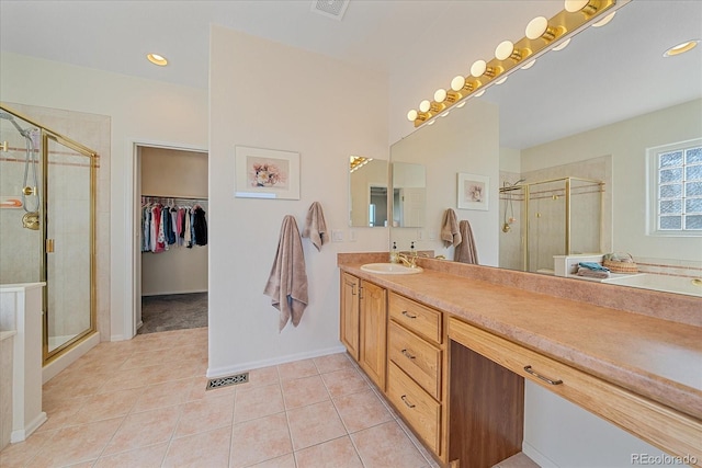 23425 E Otero Dr, Aurora, CO 80016 - full bathroom featuring vanity, a stall shower, tile patterned floors, a spacious closet, and recessed lighting