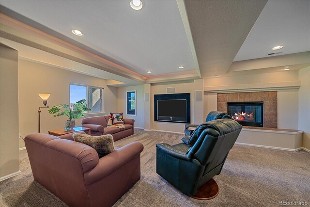 23425 E Otero Dr, Aurora, CO 80016 - carpeted living area featuring a tray ceiling, a tile fireplace, and recessed lighting