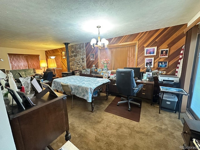 33691 Nova Rd, Pine, CO 80470 - carpeted home office featuring a textured ceiling, a chandelier, wooden walls, and a wood stove