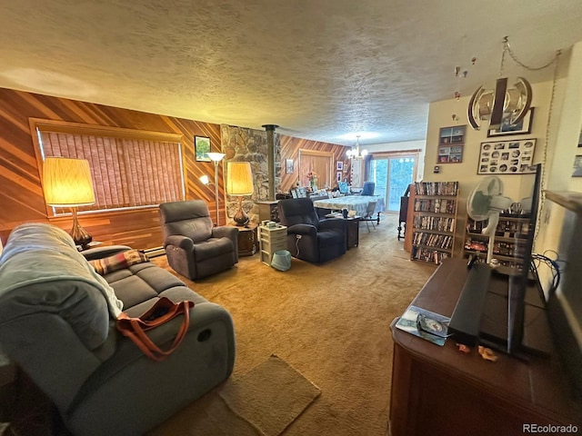 33691 Nova Rd, Pine, CO 80470 - living room featuring a chandelier, wood walls, carpet floors, and a textured ceiling