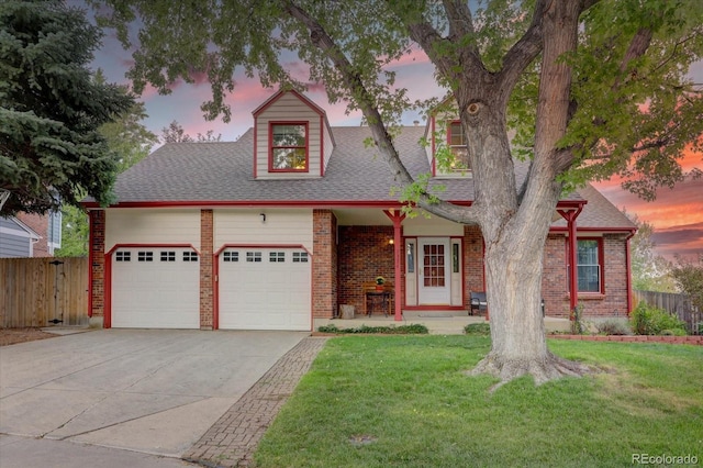 view of front facade with a lawn and a garage