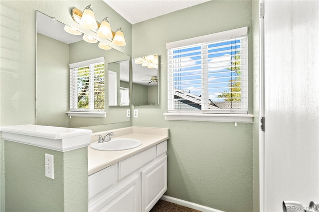 bathroom featuring a textured ceiling, vanity, and ceiling fan