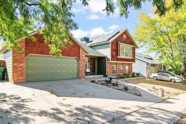 view of front of property with a garage and solar panels