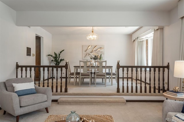 living room with carpet and a chandelier